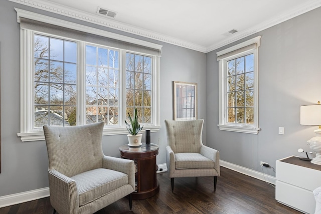 living area featuring dark wood-type flooring, visible vents, ornamental molding, and baseboards