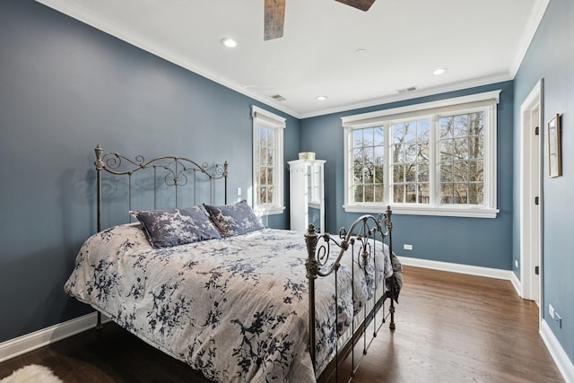 bedroom with crown molding, dark wood-style floors, and baseboards