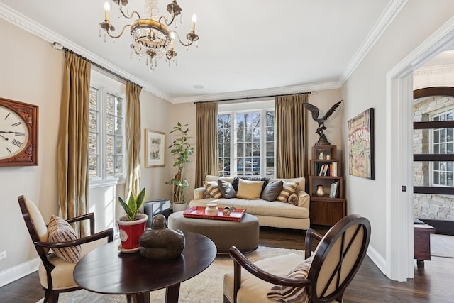 living area with dark wood-style floors, ornamental molding, a chandelier, and baseboards