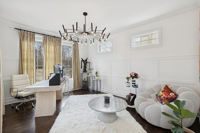 office featuring a notable chandelier, a decorative wall, dark wood-style flooring, wainscoting, and crown molding