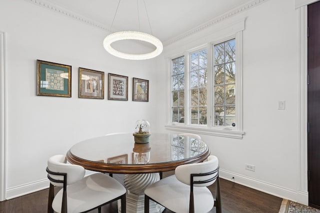 dining space with dark wood finished floors and baseboards