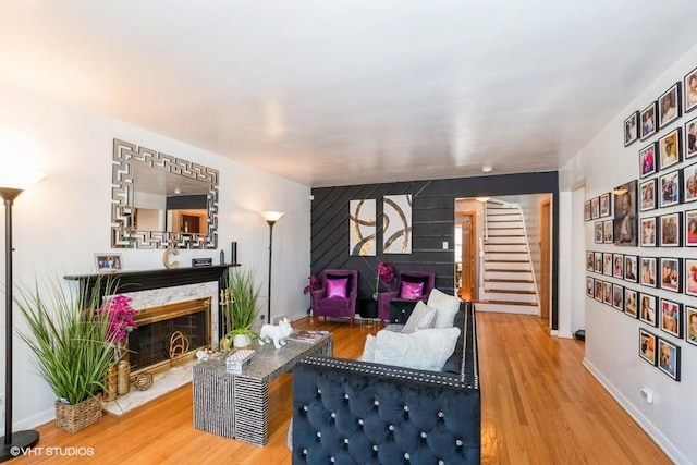 living room with a fireplace and wood-type flooring