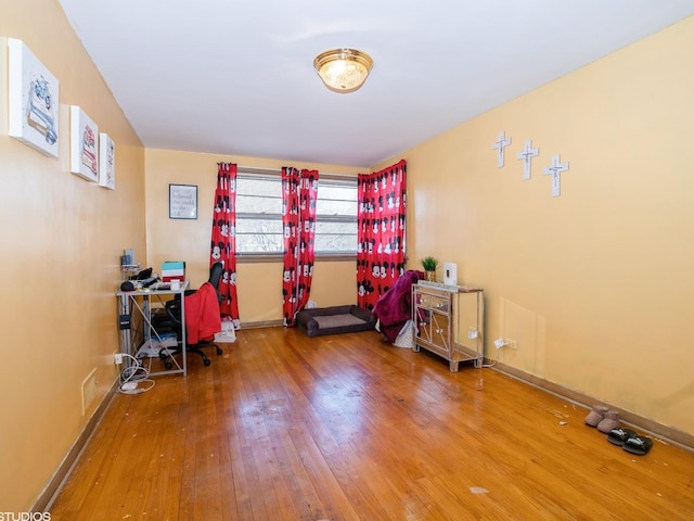 home office with wood-type flooring