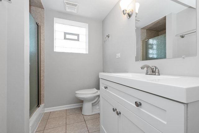 bathroom with tile patterned floors, vanity, toilet, and a shower with shower door