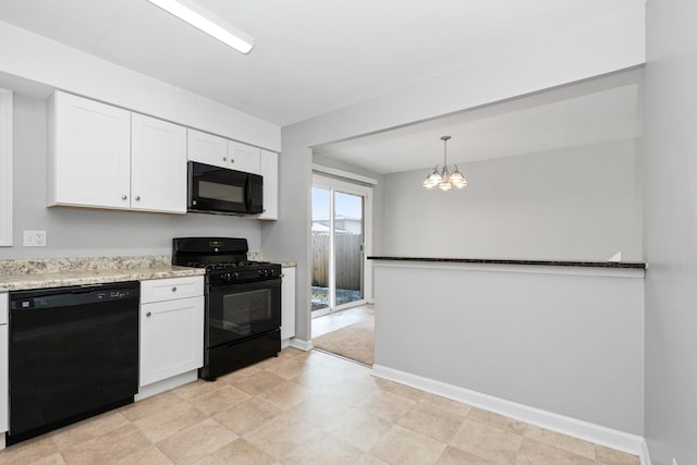 kitchen with black appliances, decorative light fixtures, white cabinets, and an inviting chandelier