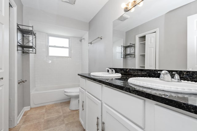 full bathroom featuring vanity, toilet, and tiled shower / bath combo