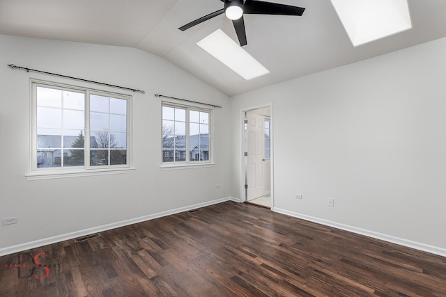 empty room with ceiling fan, dark wood-type flooring, and lofted ceiling with skylight