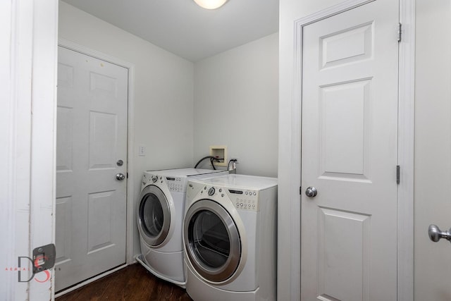 laundry area with dark hardwood / wood-style floors and separate washer and dryer