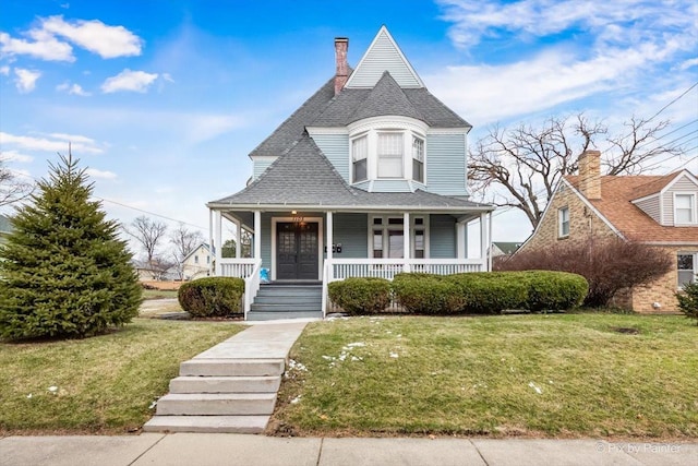 victorian home featuring a front yard and a porch