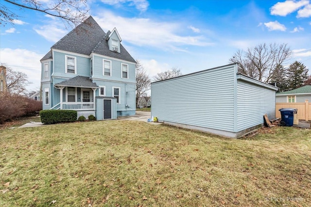 back of house with a lawn and a porch