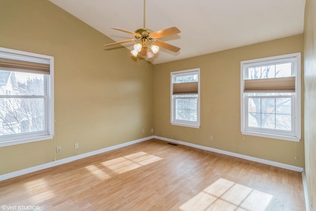 empty room featuring vaulted ceiling, ceiling fan, and light hardwood / wood-style floors