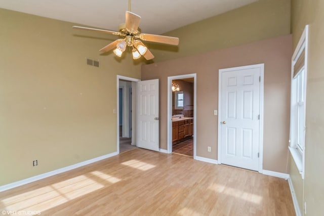 unfurnished bedroom featuring wood-type flooring, ceiling fan, and ensuite bathroom