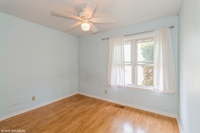 empty room featuring ceiling fan and light wood-type flooring