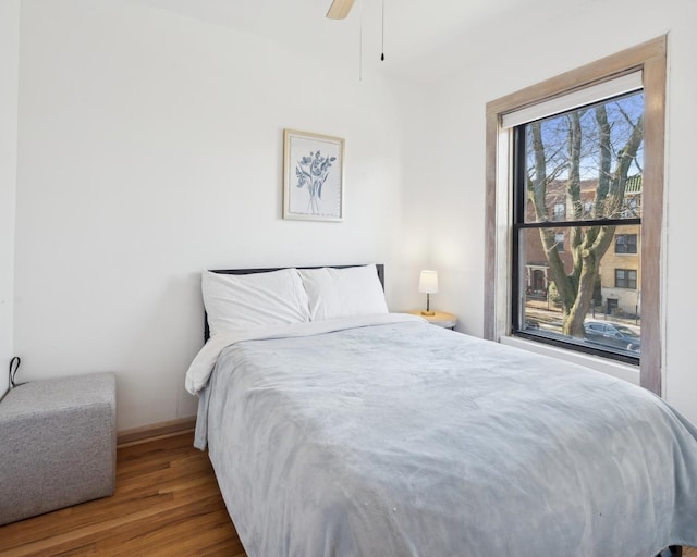 bedroom with hardwood / wood-style flooring and ceiling fan