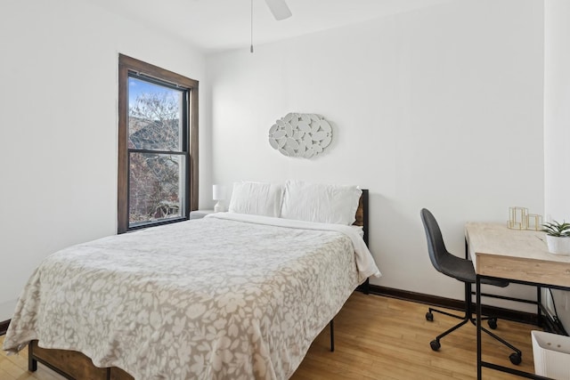 bedroom with ceiling fan and wood-type flooring