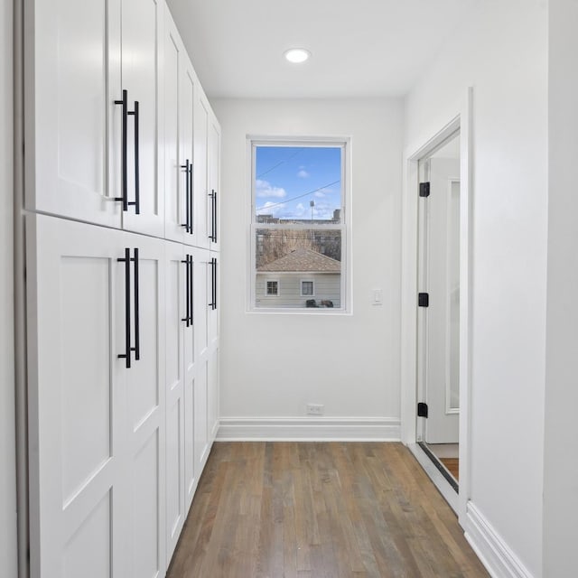 hall with hardwood / wood-style flooring