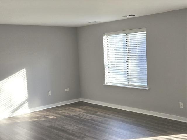 unfurnished room with dark hardwood / wood-style floors