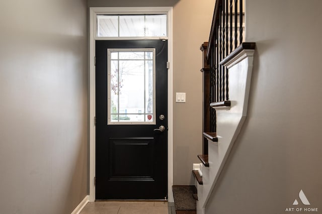 entryway with a healthy amount of sunlight and light tile patterned floors