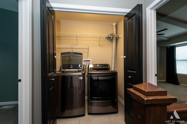 clothes washing area featuring ceiling fan, separate washer and dryer, and light tile patterned floors