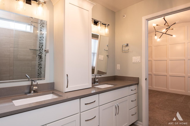 bathroom with vanity and a chandelier