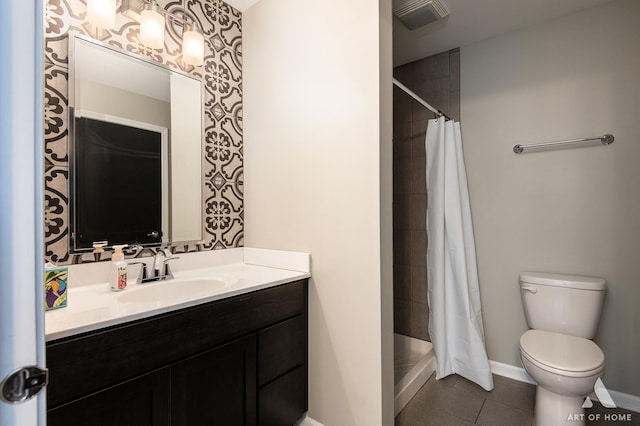 bathroom with tile patterned flooring, vanity, toilet, and curtained shower