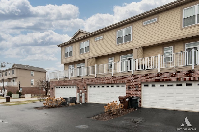 townhome / multi-family property featuring central AC and a garage