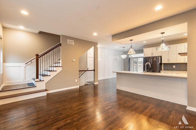 unfurnished living room featuring dark hardwood / wood-style flooring