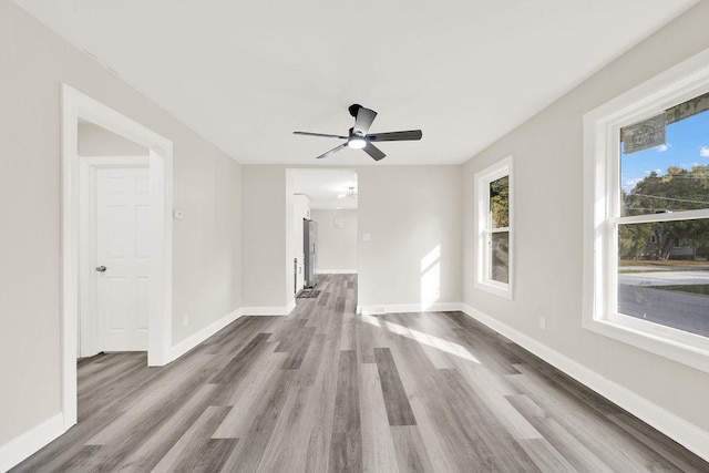 unfurnished room with ceiling fan and wood-type flooring