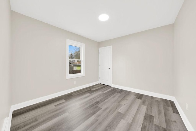 unfurnished room with hardwood / wood-style floors