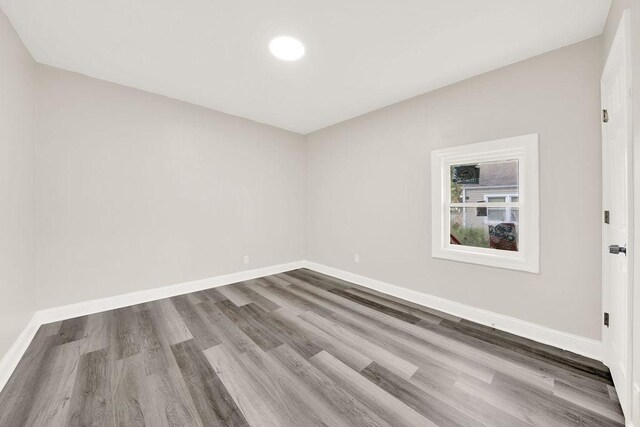 unfurnished room featuring wood-type flooring