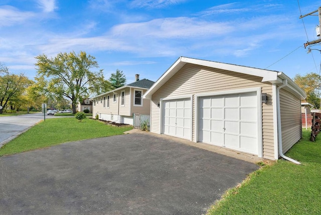 view of front of property with a front yard and a garage