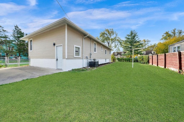 view of property exterior with a yard and cooling unit