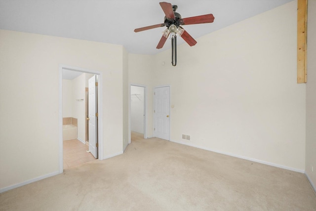 empty room with ceiling fan and light carpet