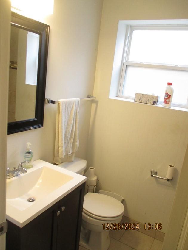 bathroom featuring tile patterned flooring, vanity, and toilet