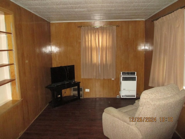 living room with heating unit and wooden walls