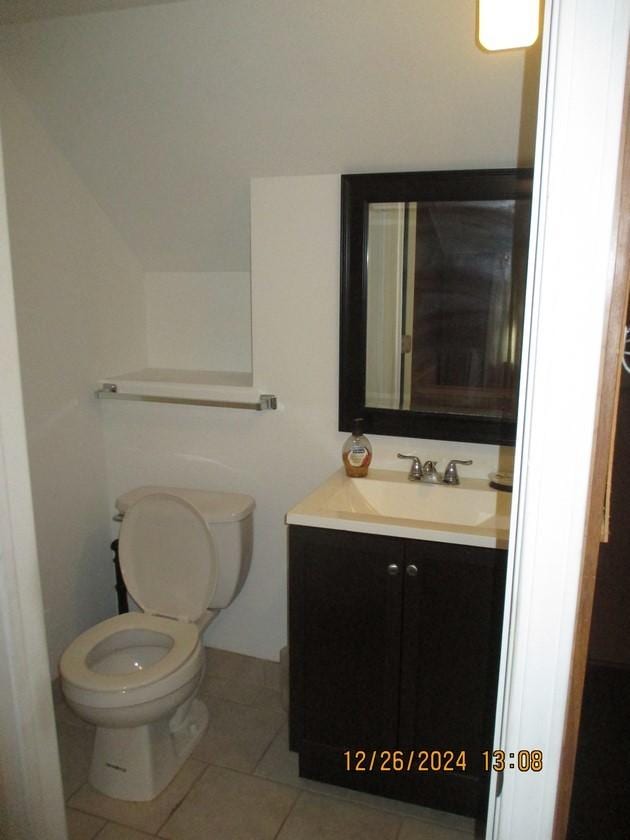 bathroom featuring tile patterned floors, vanity, and toilet