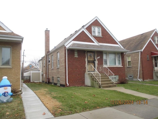 bungalow-style home with a front lawn