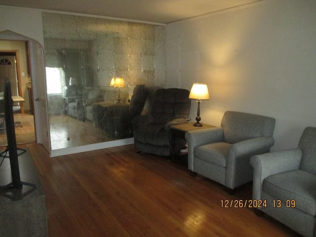 living area featuring dark hardwood / wood-style flooring and ornamental molding