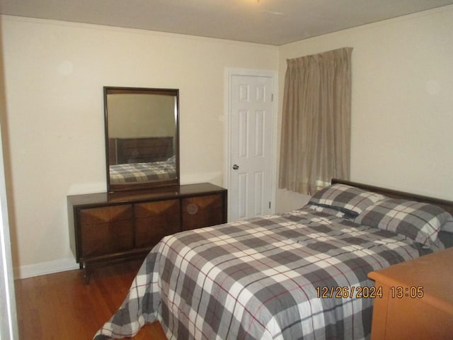 bedroom with dark wood-type flooring