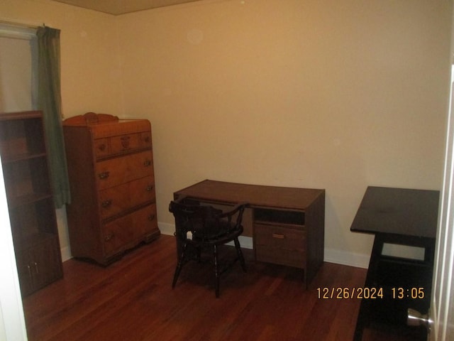 home office with dark wood-type flooring