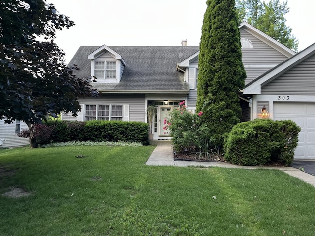 cape cod house featuring a garage and a front yard