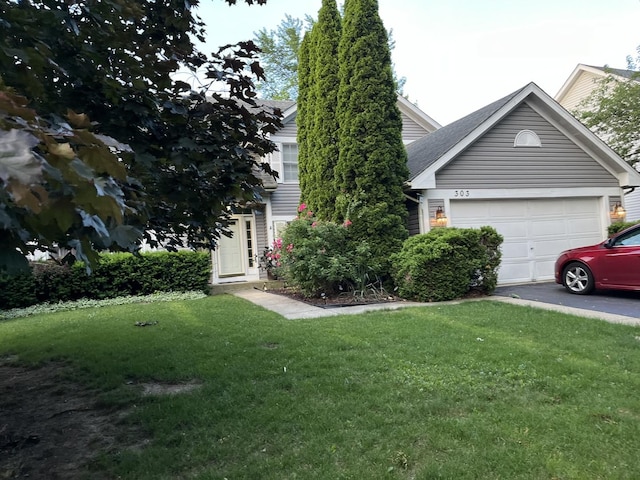 obstructed view of property with a front yard and a garage