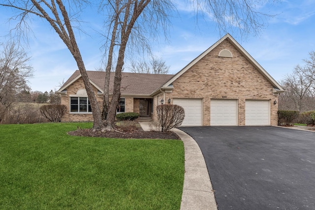 view of front of house with a garage and a front lawn