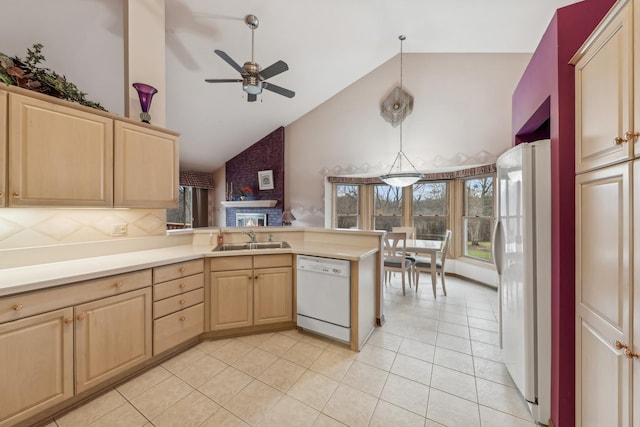 kitchen featuring sink, high vaulted ceiling, pendant lighting, white appliances, and light brown cabinetry