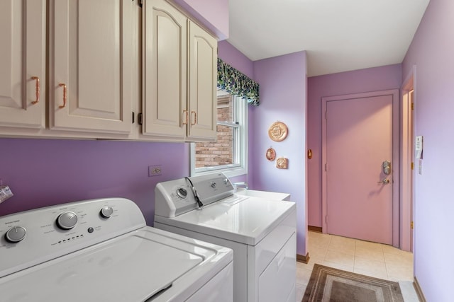 laundry area with light tile patterned floors, cabinets, and independent washer and dryer