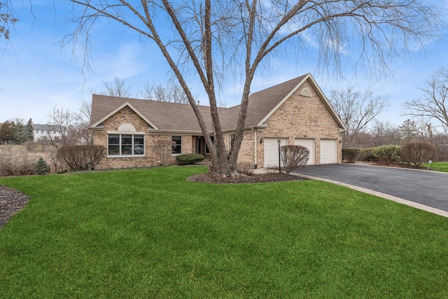 view of front of property with a front yard and a garage