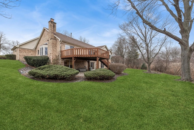 back of property featuring a lawn and a deck