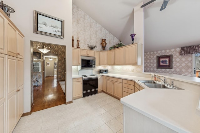 kitchen featuring kitchen peninsula, light brown cabinetry, sink, electric stove, and high vaulted ceiling