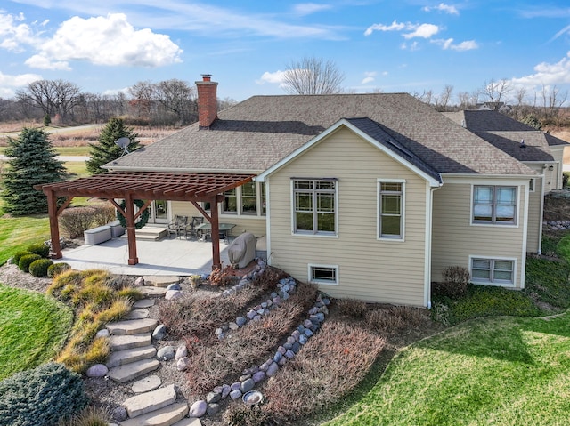 back of house featuring a patio, a pergola, and a lawn