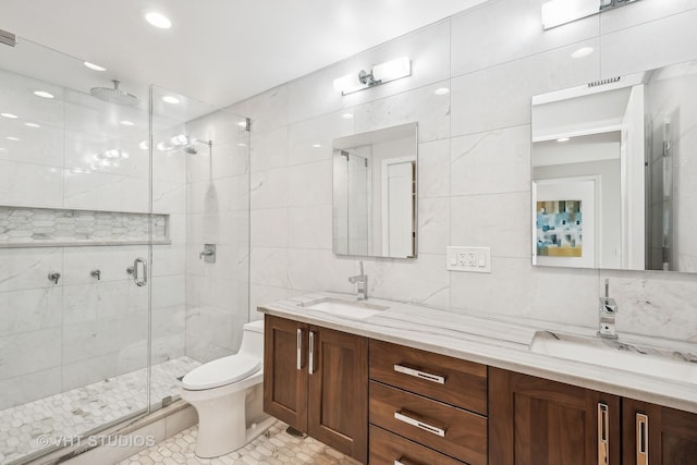 bathroom with toilet, tile patterned flooring, tile walls, walk in shower, and vanity